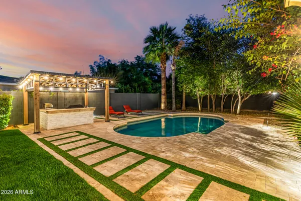 a view of a play ground in front of a house with a yard