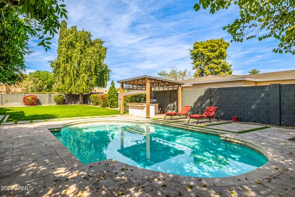 an aerial view of a city with lots of residential buildings ocean and mountain view in back