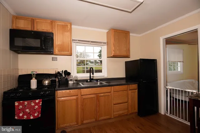 a kitchen with a sink stove and microwave