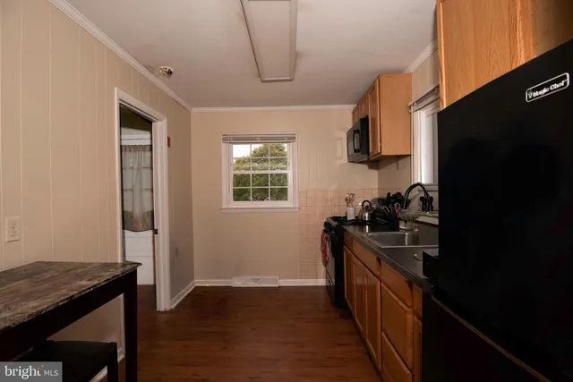 a kitchen with a sink appliances and cabinets