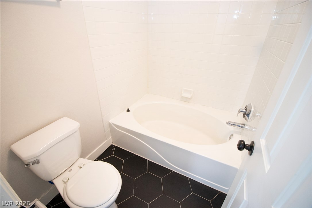 1468 Reef Ridge Court Las Vegas, NV 89128 - Photo 20 of 22 Clean lines and a spacious tub offer a serene escape in this private bathroom.