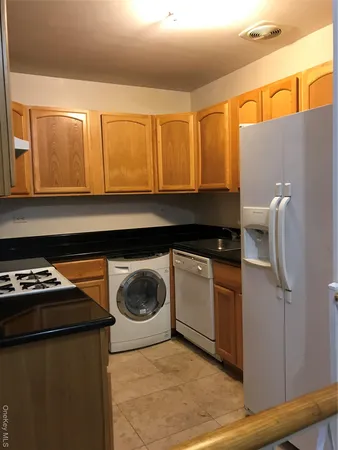 a kitchen with a sink a stove and cabinets
