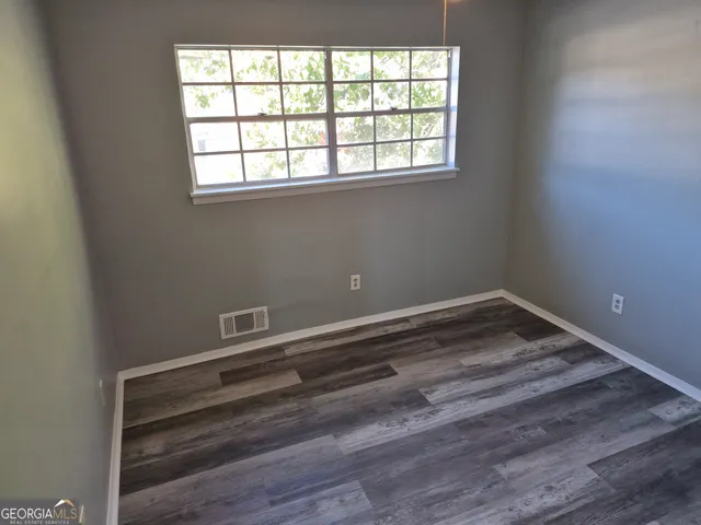 a view of a room with wooden floor