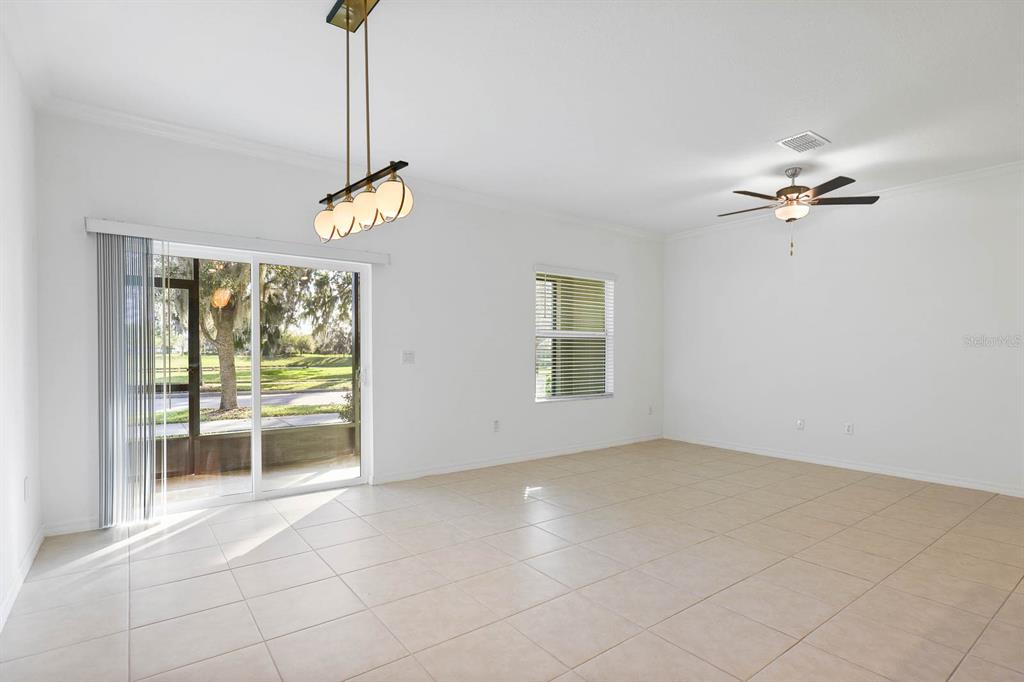 13755 Big Hawk Way Lithia, FL 33547 - Photo 14 of 33 a view of a room with cabinet a ceiling fan and a window