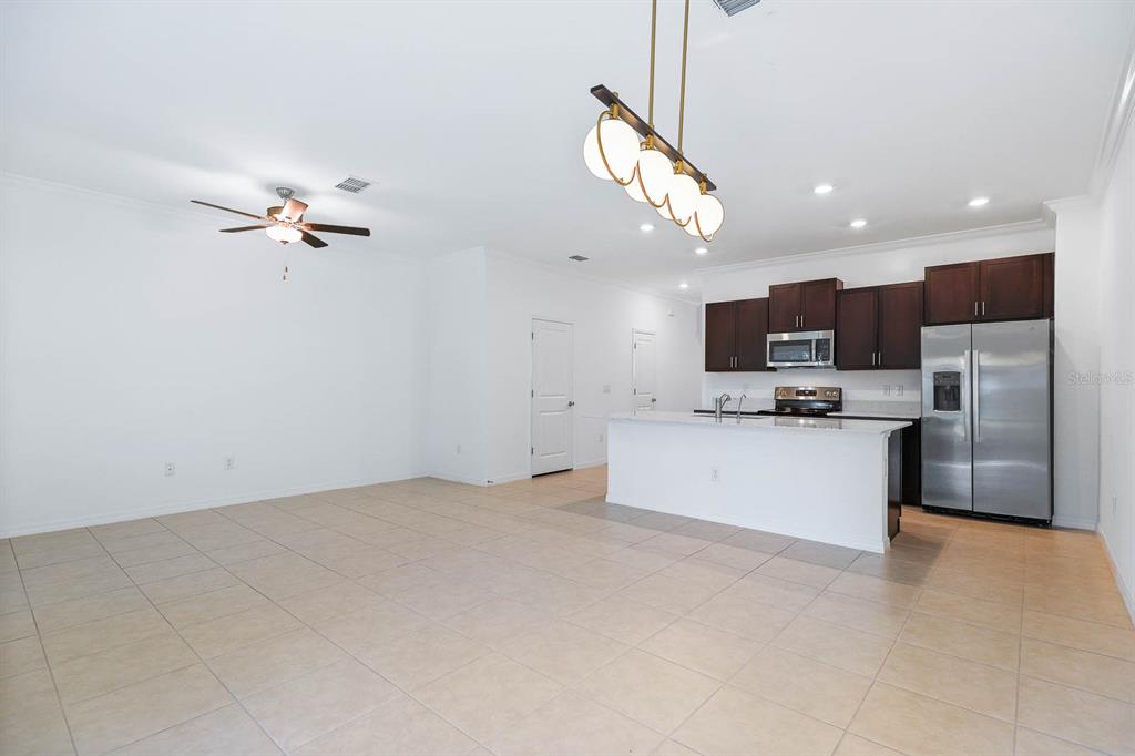 13755 Big Hawk Way Lithia, FL 33547 - Photo 15 of 33 a view of kitchen with microwave a stove and a refrigerator