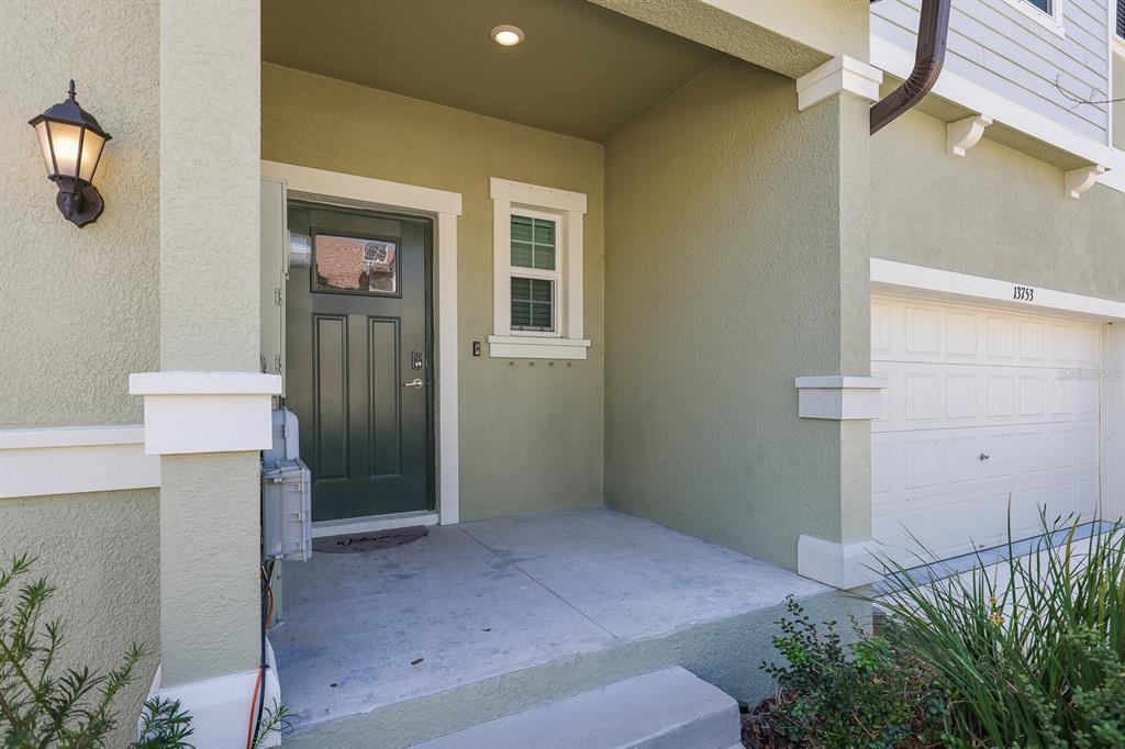 13755 Big Hawk Way Lithia, FL 33547 - Photo 2 of 33 a bedroom with a bed and a potted plant