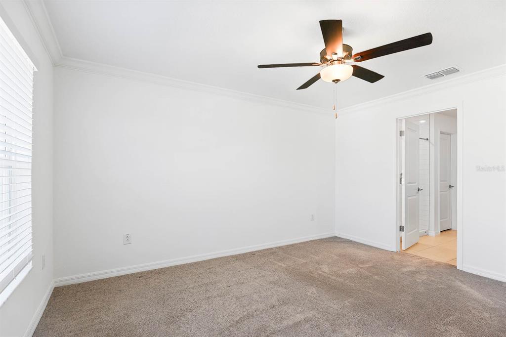 13755 Big Hawk Way Lithia, FL 33547 - Photo 21 of 33 an empty room with a window and a fan