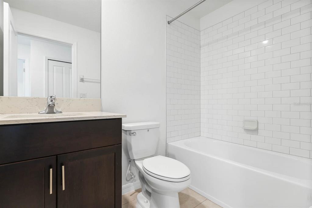 13755 Big Hawk Way Lithia, FL 33547 - Photo 27 of 33 a bathroom with a sink toilet vanity and bathtub