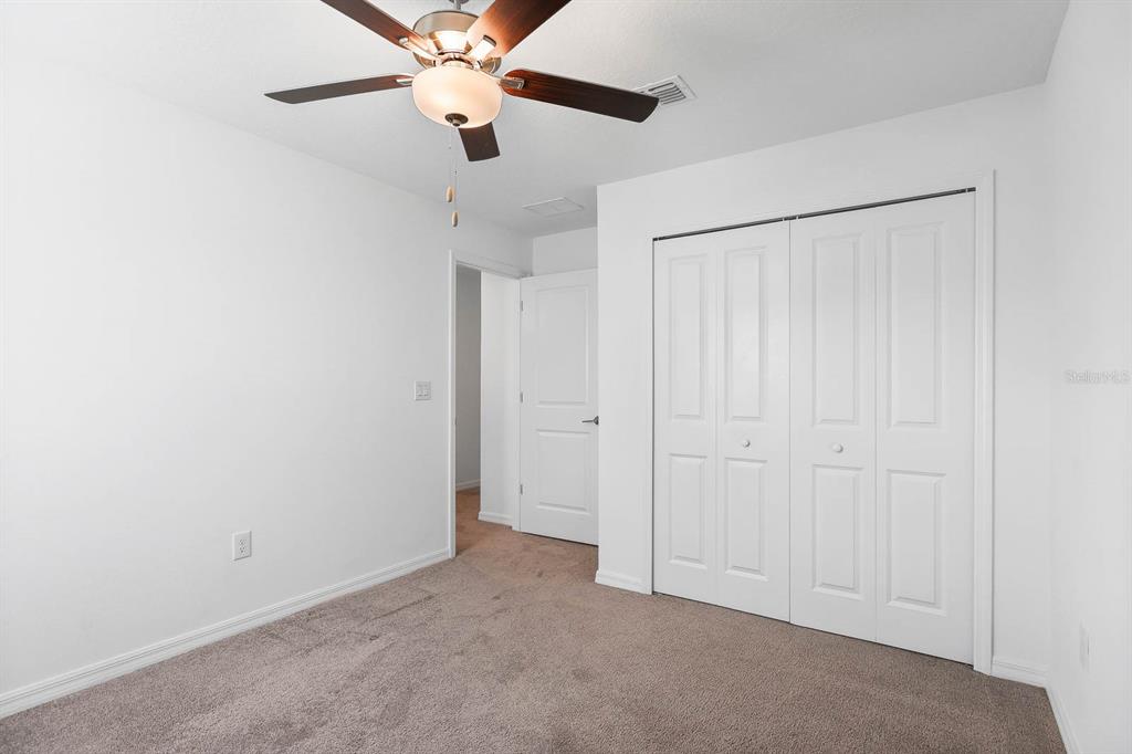 13755 Big Hawk Way Lithia, FL 33547 - Photo 29 of 33 an empty room with a ceiling fan and a window