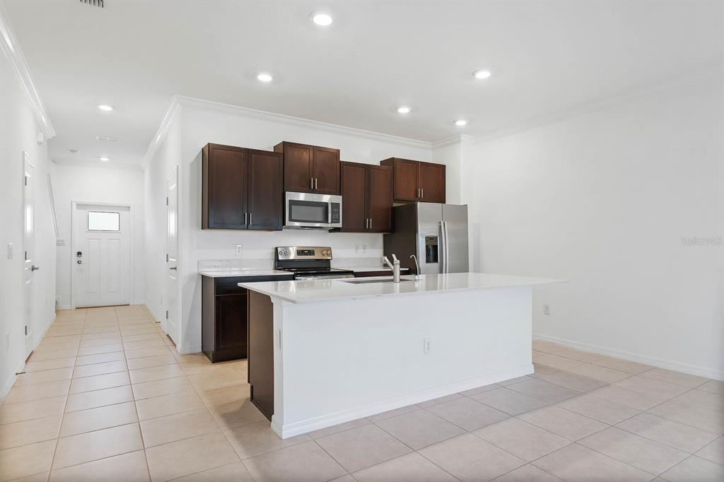13755 Big Hawk Way Lithia, FL 33547 - Photo 7 of 33 a view of kitchen with stainless steel appliances a sink and a stove