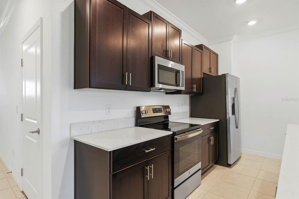 13755 Big Hawk Way Lithia, FL 33547 - Photo 9 of 33 a kitchen with a refrigerator sink and microwave