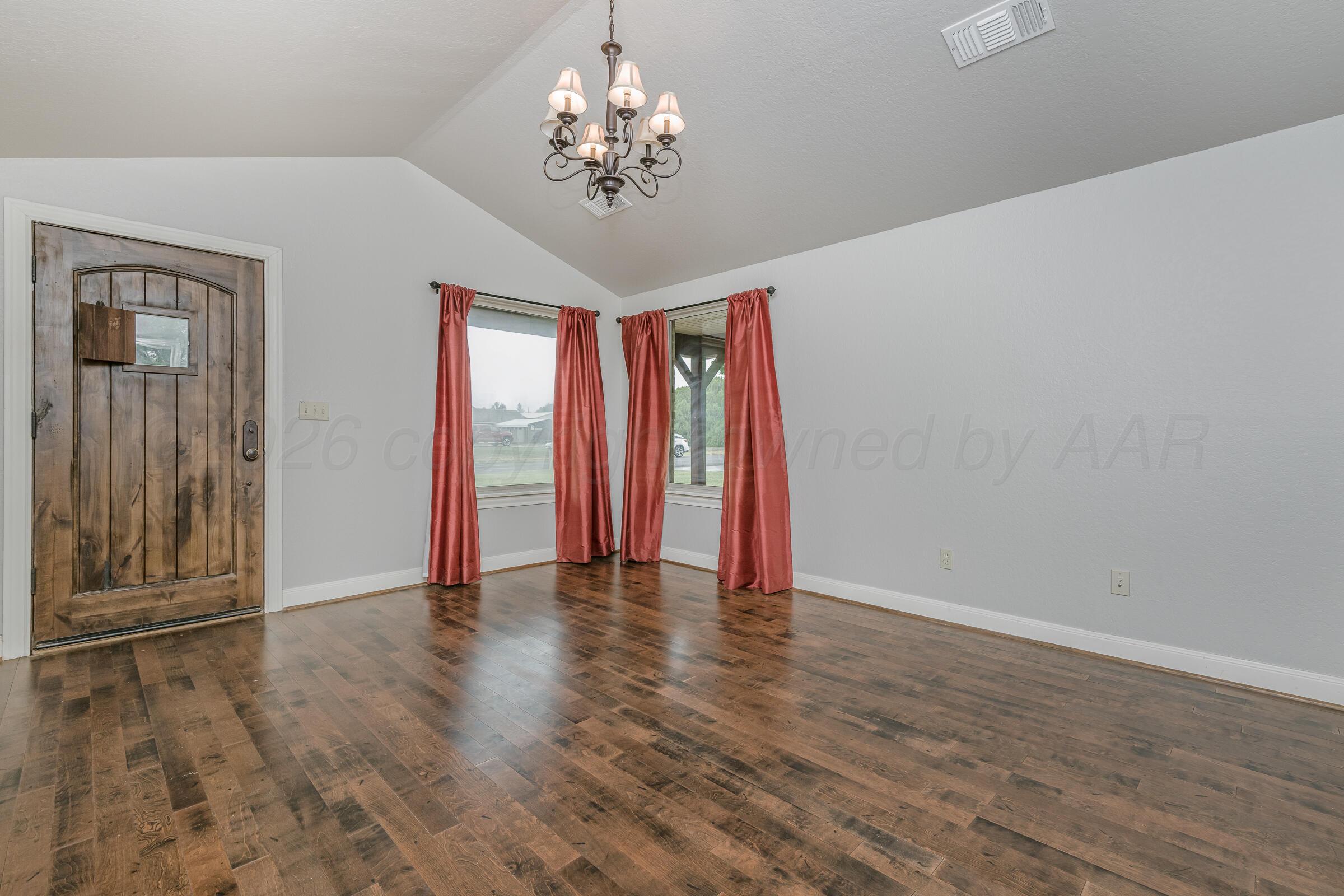 4400 West Farmers Avenue Amarillo, TX 79110 - Photo 5 of 27 a view of an empty room with wooden floor