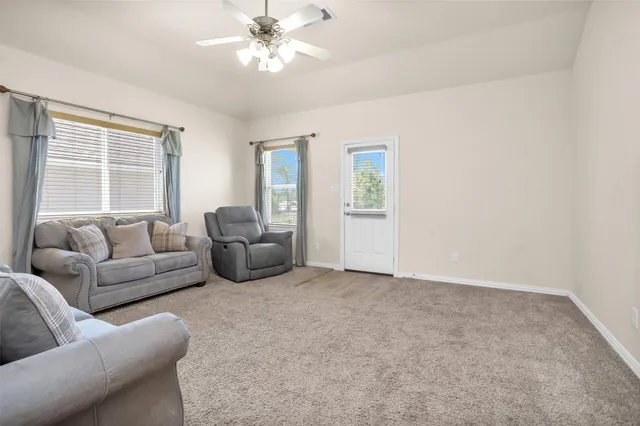 a view of kitchen with kitchen island a sink wooden floor and a refrigerator