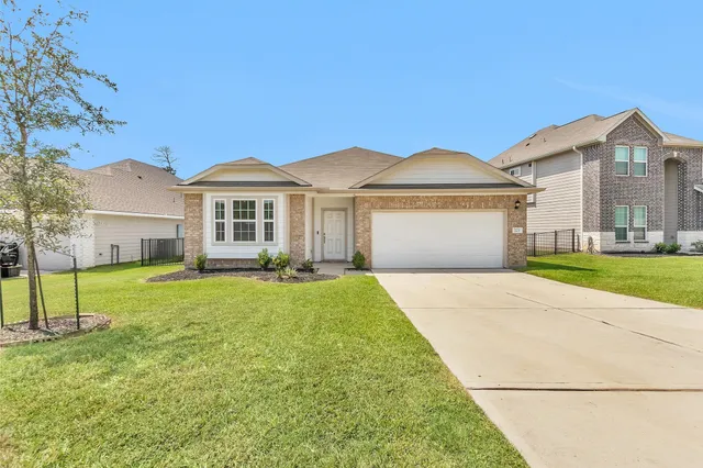 a front view of a house with a yard and porch