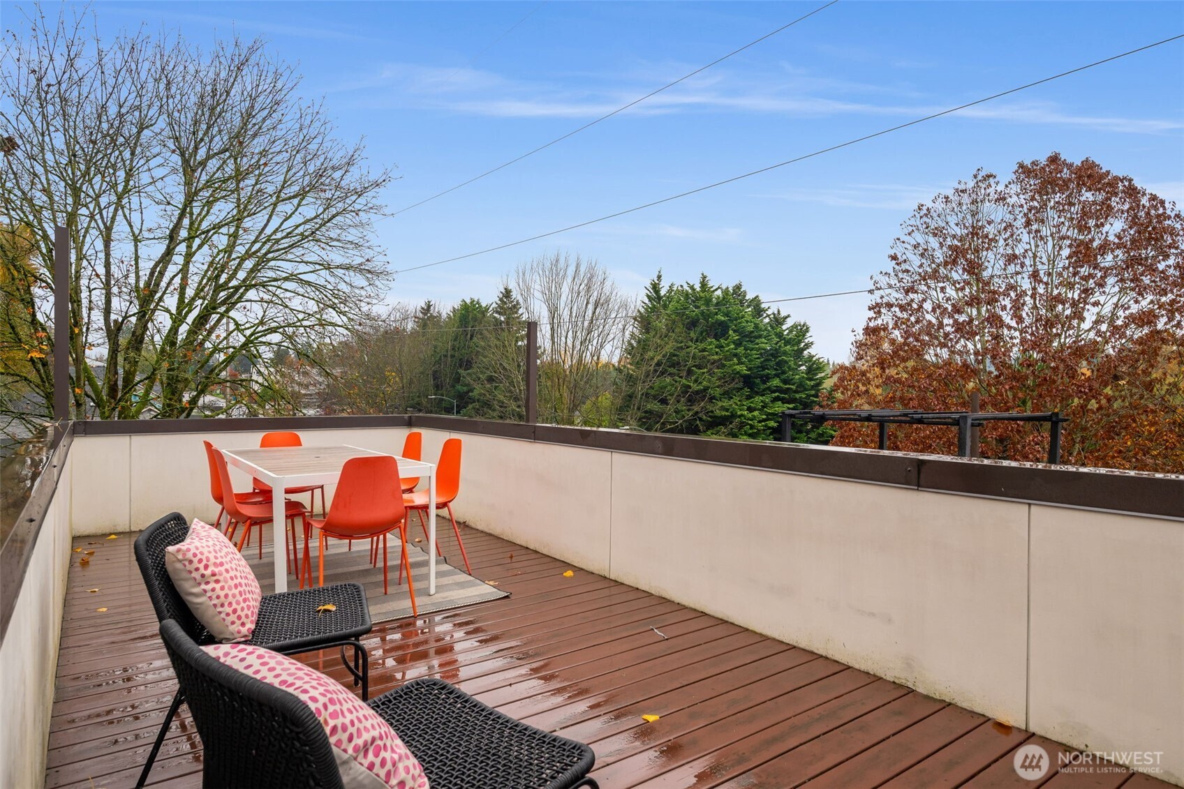 7758 Delridge Way Southwest Seattle, WA 98106 - Photo 18 of 22 a balcony with wooden floor and outdoor seating