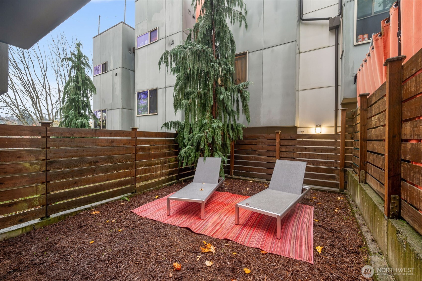 7758 Delridge Way Southwest Seattle, WA 98106 - Photo 20 of 22 a wooden bench sitting in front of a building