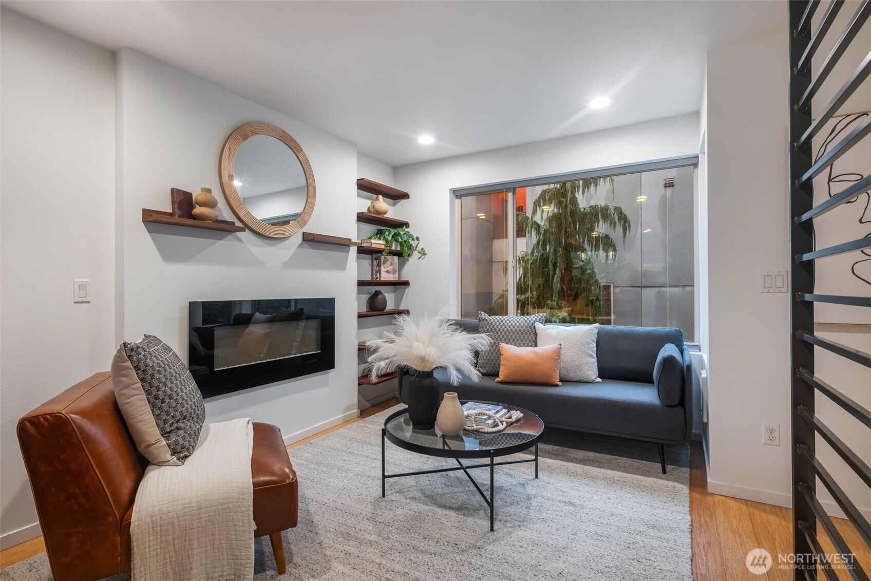 7758 Delridge Way Southwest Seattle, WA 98106 - Photo 2 of 22 a living room with furniture a fireplace a rug and a large window