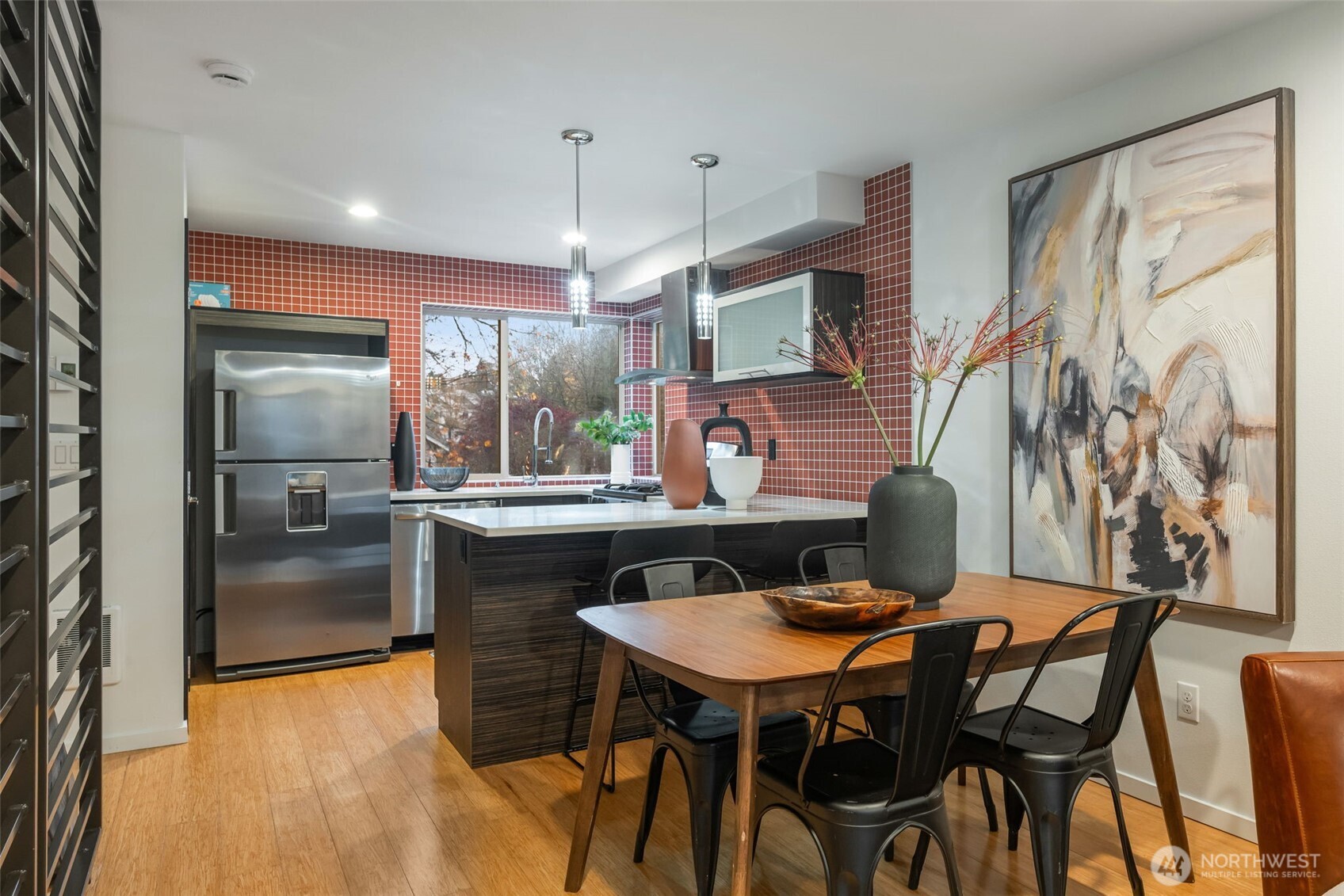 7758 Delridge Way Southwest Seattle, WA 98106 - Photo 5 of 22 a kitchen with stainless steel appliances granite countertop a kitchen island a table and chairs in it
