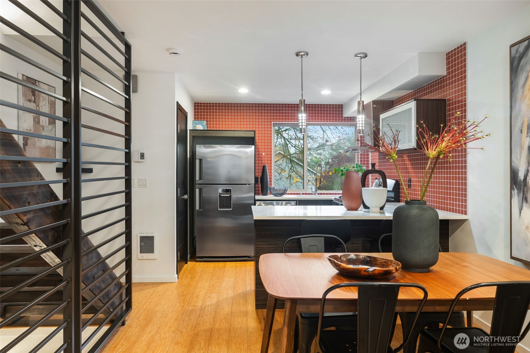 7758 Delridge Way Southwest Seattle, WA 98106 - Photo 6 of 22 a kitchen area with stainless steel appliances kitchen island granite countertop a table and chairs