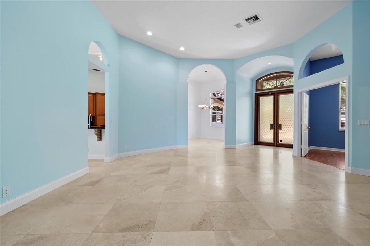6989 Cypress Cove Circle Jupiter, FL 33458 - Photo 11 of 47 a view of a hallway with wooden floor and windows