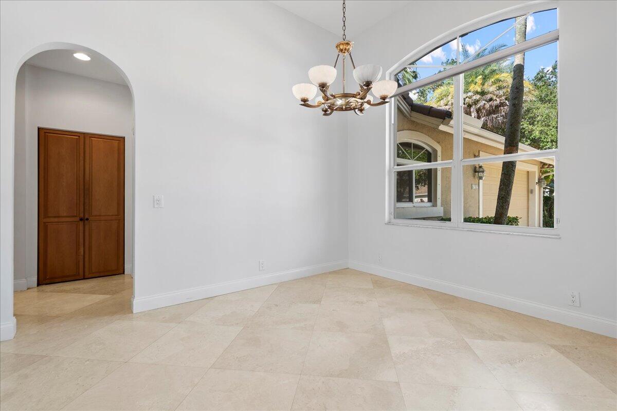 6989 Cypress Cove Circle Jupiter, FL 33458 - Photo 14 of 47 wooden floor in an empty room with a window