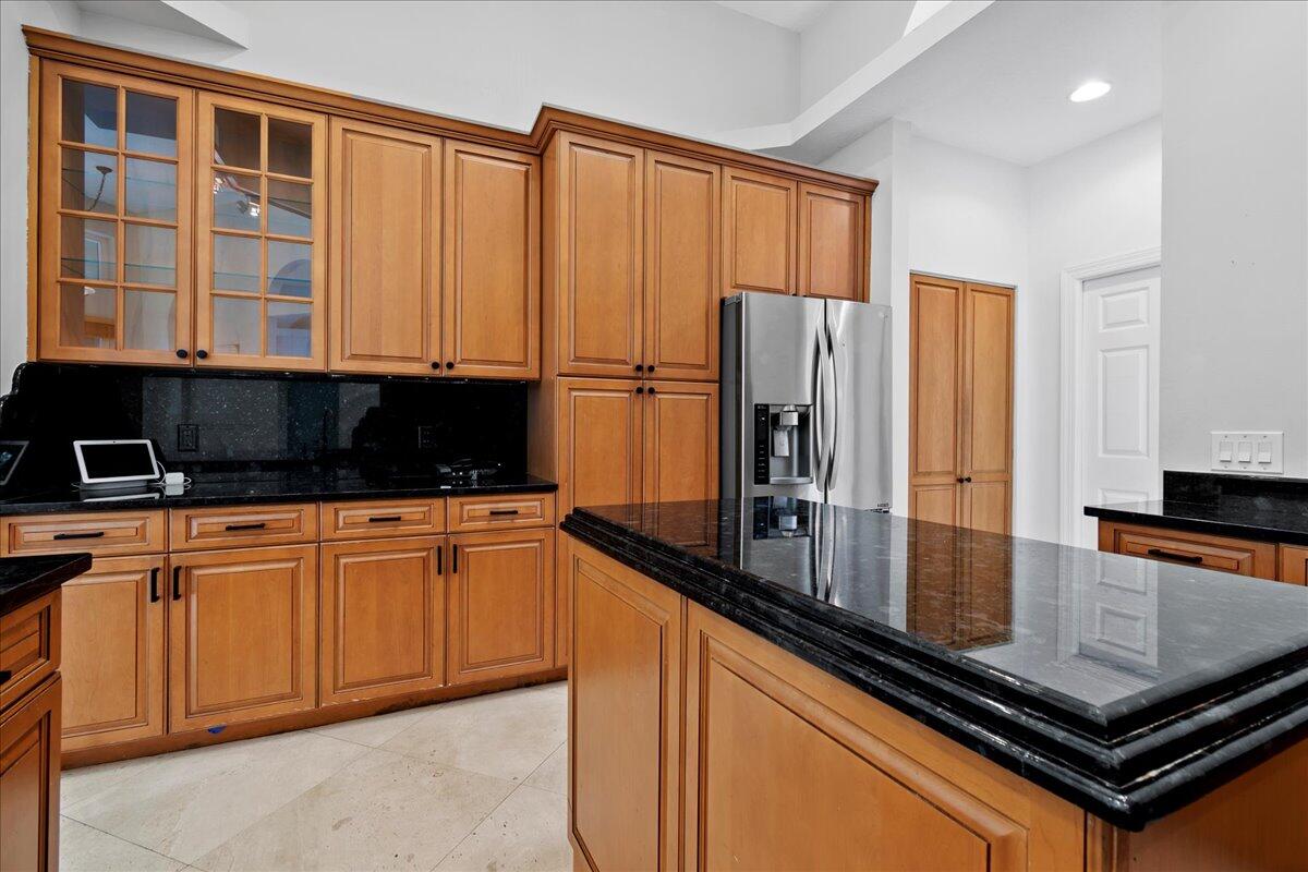 6989 Cypress Cove Circle Jupiter, FL 33458 - Photo 17 of 47 a kitchen with stainless steel appliances granite countertop a refrigerator and a sink