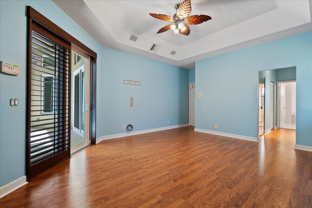 6989 Cypress Cove Circle Jupiter, FL 33458 - Photo 27 of 47 wooden floor in an empty room with a window