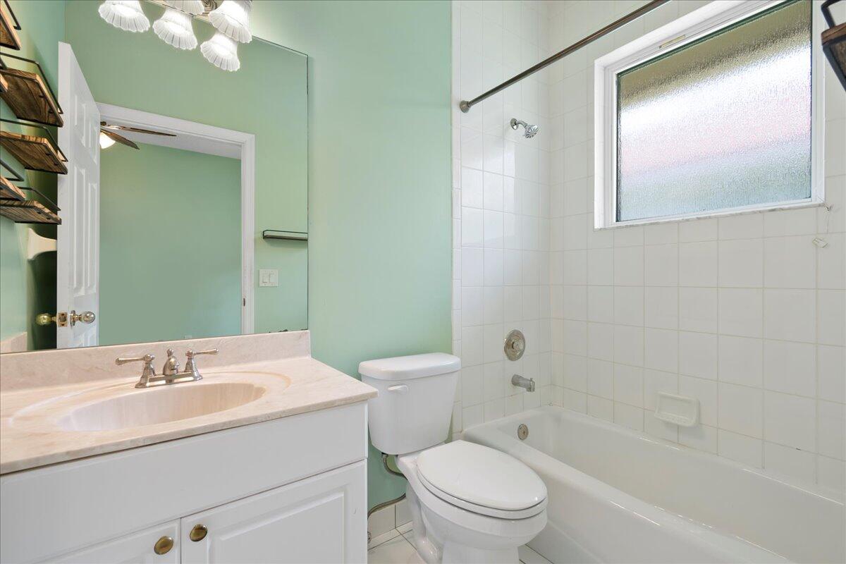 6989 Cypress Cove Circle Jupiter, FL 33458 - Photo 35 of 47 a bathroom with a sink a toilet and shower