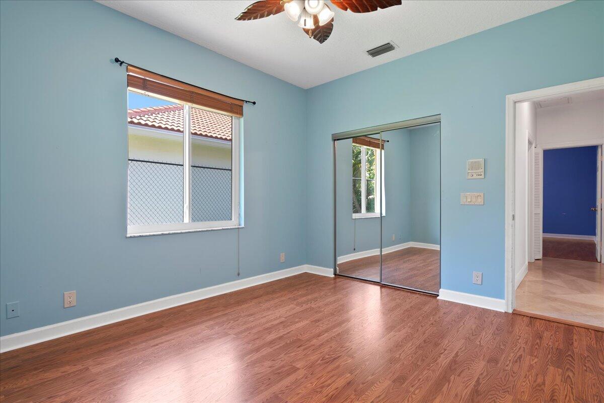 6989 Cypress Cove Circle Jupiter, FL 33458 - Photo 37 of 47 a view of empty room with wooden floor and fan