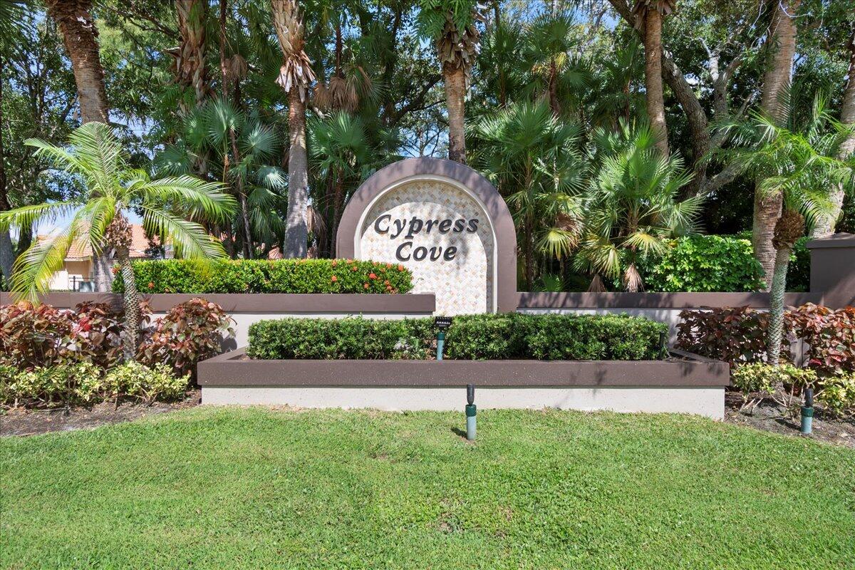 6989 Cypress Cove Circle Jupiter, FL 33458 - Photo 38 of 47 a front view of a house with a garden
