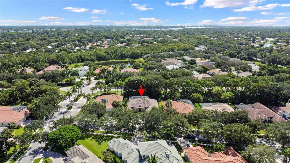 6989 Cypress Cove Circle Jupiter, FL 33458 - Photo 40 of 47 an aerial view of residential houses with outdoor space and trees