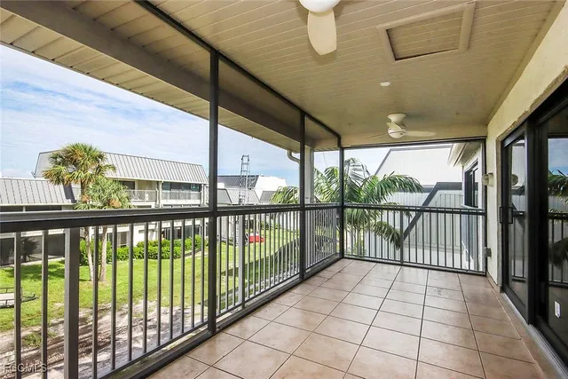 a view of a house with a patio and a yard