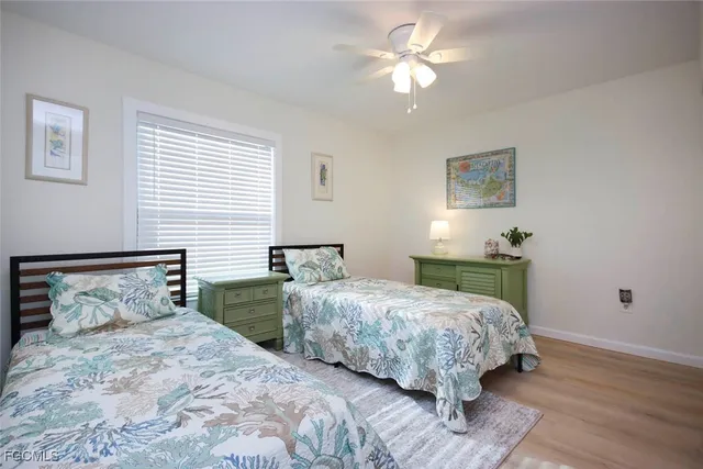 a bathroom with a bathtub shower sink vanity mirror and toilet