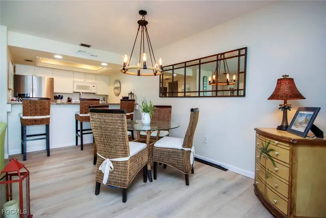 a dining room with furniture and wooden floor