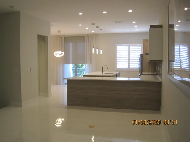 a bathroom with a sink a mirror and a bathtub next to a window