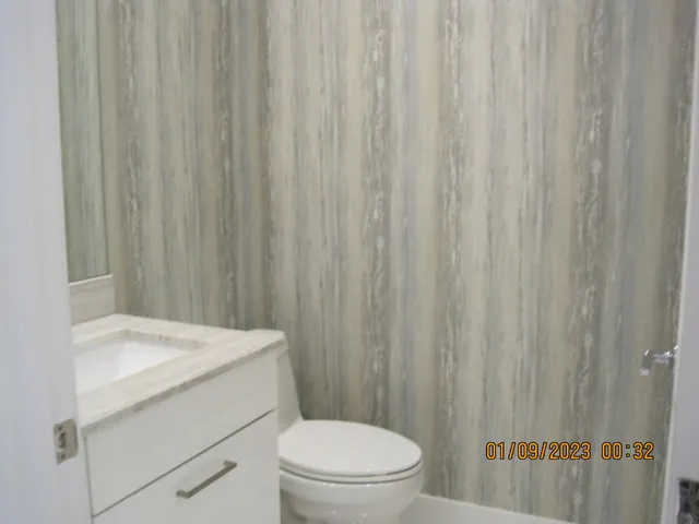 a bathroom with a toilet a sink and curtain
