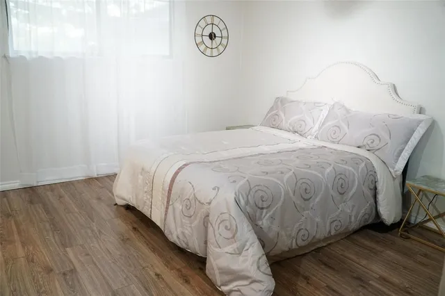 a bed sitting in a bedroom next to a window