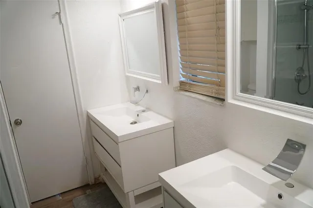 a kitchen with granite countertop a stove a sink and a microwave