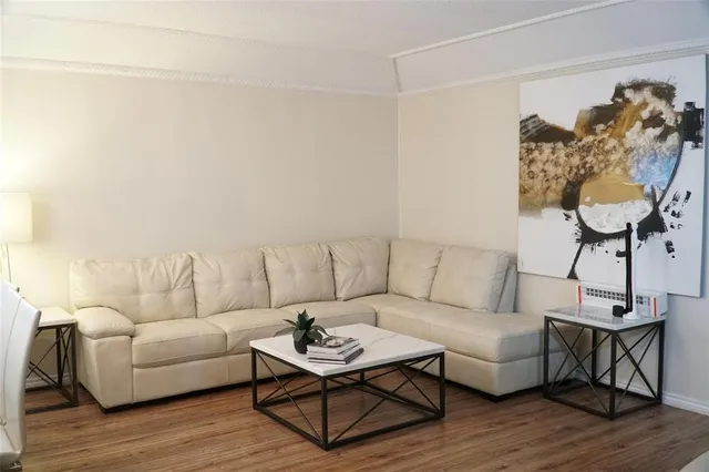 a living room with furniture a dining table and a chandelier