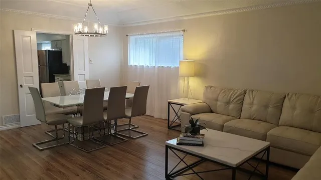 a bed sitting in a living room next to a window