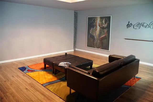 a living room with furniture rug and wooden floor