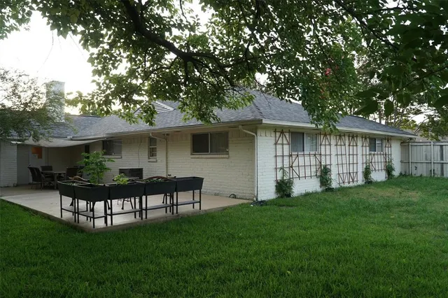 a view of a house with a yard and sitting area