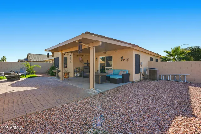 a view of a house with backyard and a tree