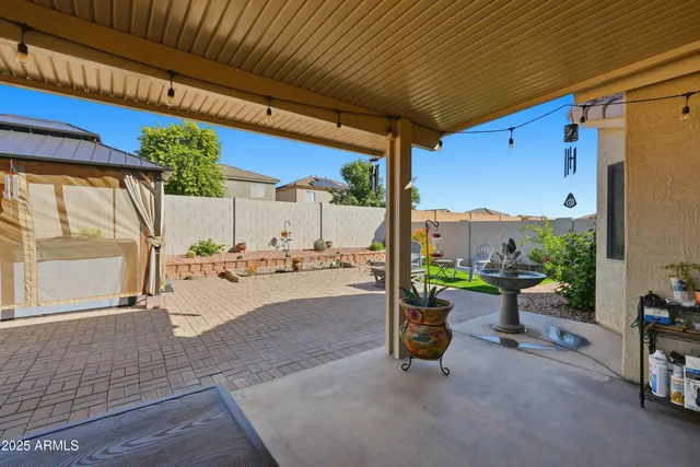 a building outdoor space with patio furniture and potted plants