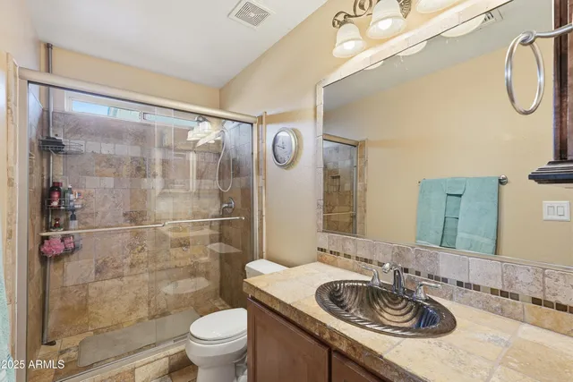 a bathroom with a sink a toilet and a mirror