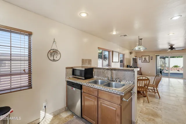 a kitchen with granite countertop a stove and cabinets