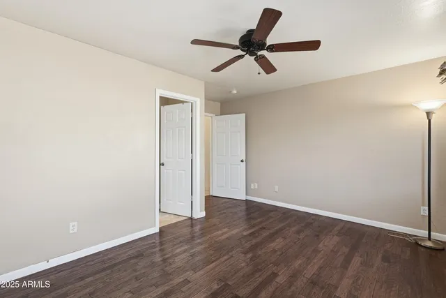a view of room with wooden floor and fan