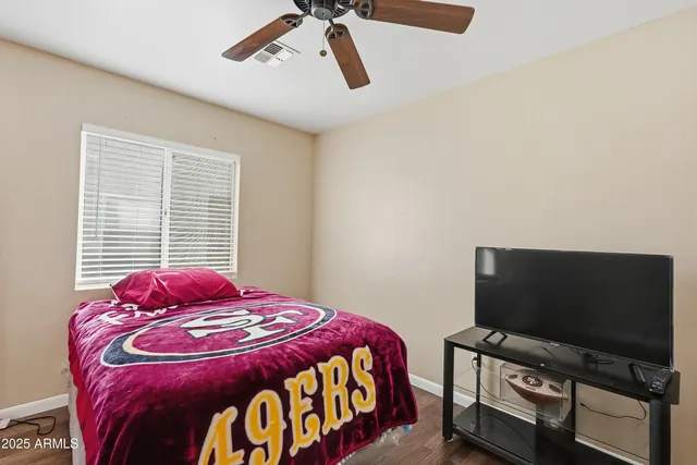 a bedroom with a bed and a flat screen tv