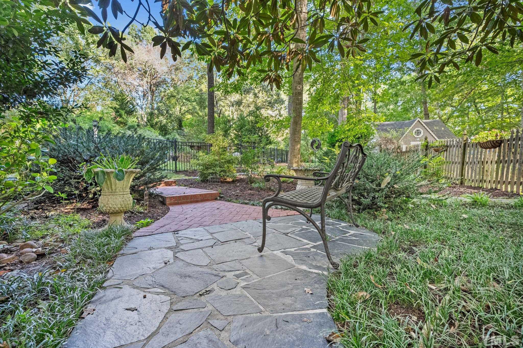 386 St Marys Road Hillsborough, NC 27278 - Photo 46 of 64 a view of a bench in a garden