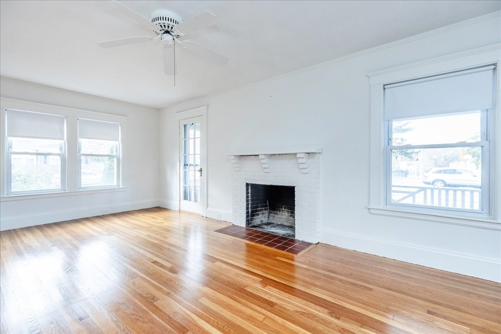 2 Martin Street Marblehead, MA 01945 - Photo 11 of 40 wooden floor fireplace and windows in an empty room